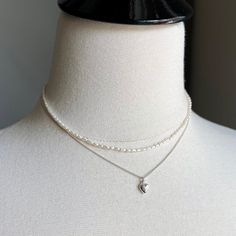 "There are 2 necklaces in this listing.   Necklace 1:   Sterling silver puff heart hangs from a tiny curb chain in bright 925 sterling silver. Details of Necklace 1: - Length of the necklace - 16\" with the option to add a 1.5\" extender chain - Dainty sterling silver curb chain (approx 1mm) & sterling silver lobster trigger clasp - Dainty puff heart in sterling silver - 6X9mm Necklace 2:  Tiny white freshwater pearl necklace with sterling silver lobster clasp.  Details of Necklace 2: - Length o