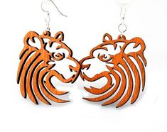 Made In U.S.A Style # 1094 Size 1.8" x 1.6" Tiger Earrings The tiger is the largest wild cat in the world. The beautiful cat can weigh up to 720 lbs! Made from sustainably sourced wood and 90% recycled display cards. Laser-cut wood Stained with water based dye Ear wires are silver-finished 304L stainless steel, hypoallergenic, and enhanced with a new, smooth and consistent electrophoretic coating that resists tarnishing. Earrings shown in color Tangerine Laser Earrings, Tiger Wood, Tiger Earrings, Lazer Cut, Laser Cut Jewelry, Laser Art, Earring Tree, Jewelry Tree, The Tiger