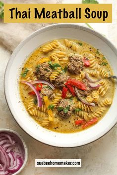 a white bowl filled with meatball soup and red onions