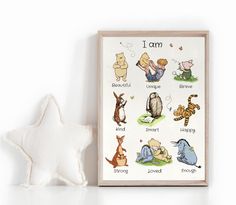 a white star next to a wooden frame with cartoon animals on it and the words i am written in different languages