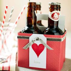 two beer bottles in a red box with a heart tag