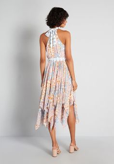 You will feel like a mystical garden pixie in this ultra-unique sleeveless midi dress. Made from  flowy lightweight woven fabric, this dress boasts an all over patchwork style print of five different floral patterns in soft pastel shades of pink, blue, ivory, and orange. Featuring a mock neck halter neckline with tie closure at the back, a gathered waistline, and a fluttering asymmetrical handkerchief hemline, this ultra-feminine frock is perfect for accentuating the softer side of the spring and summer seasons. For an added hint of soft contrast, the white tie-neck detailing and removable sash tie-belt feature a matching pastel blue-hued polka-dot print that makes this darling piece both pretty and playful. Shell: 100% Polyester. Lining: 95% Polyester, 5% Elastane. Hand wash. Fully lined. Mystical Garden, Cute Red Dresses, Pastel Dress, Mod Cloth Dresses, Womens Vintage Dresses, Sleeveless Midi Dress, Pastel Shades, Shades Of Pink, Blue Ivory