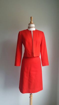 An intense, saturated red brightens any occasion, from the office to after hours. Clean, tailored lines and a slim fit add a '60s mod appeal. Set includes pencil skirt and open jacket with no closures. Fine wool exterior; fully lined in nylon satin. Era: 1990s Label: Pendleton JACKET (somewhat open fit, no closures) Bust: up to 34-36 inches Length from shoulder to hem: 19 inches SKIRT Waist up to 26 inches Hips/seat: up to 37 inches Length: 24.5 inches Tailored Red Skirt Suit For Office, Fall Formal Red Skirt Suit, Red Fitted Skirt Suit For Party, Elegant Red Skirt Suit For Work, Elegant Red Fitted Skirt Suit, Classic Red Skirt Suit For Work, Red Fitted Blazer For Career, Fitted Red Skirt Suit With Long Sleeves, Red Fitted Long Sleeve Skirt Suit