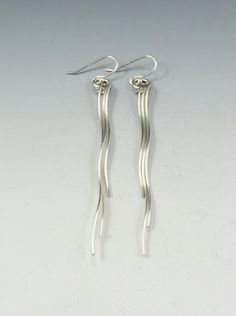 Sterling silver spiral earrings. These are a graceful design that measure 2" in length and hang from sterling ear wires. Rubber stoppers are also supplied with each pair for security.Created from responsibly sourced materials where possible. Each piece is handmade, because of this there may be slight variations in your finished piece from the photo shown. Please allow 1-2 weeks for fabrication and delivery.Free shipping is only available in Canada and United States. International customers, plea Modern Twist Silver Jewelry With Ear Wire, Silver Dangle Wrap Earrings With Ear Wire, Modern Twist Dangle Earrings With Ear Wire, Modern Twist Metal Earrings With Ear Wire, Silver Spiral Wrap Earrings In Sterling Silver, Modern Twist Sterling Silver Jewelry With Ear Wire, Minimalist Spiral Silver Wrap Earrings, Minimalist Spiral Earrings With Ear Wire, Silver Long Drop Wire Wrapped Earrings