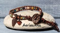 Passage Leather Wrap Bracelet by Aerieanna Made with 100% USA naturally dyed leather in dark brown and an assortment of gemstone beads that can include African Turquoise, Lapis Lazuli, Red Jasper, Clear Quartz, Rose Quartz, Landscape Jasper, Unikite, Carnelian, Mookite, Sodalite, Amethyst with two Czech fire-polished crystals. Wire wrapped beady dangles. Closes with a copper shell button at 7.5 or 8.5". Not your size? Request a custom order! Leather Gemstone Bracelet, Brown Natural Stone Wrap Bracelet For Festivals, Festival Brown Wrap Bracelet With Natural Stones, Festival Natural Stones Brown Wrap Bracelet, Brown Leather Bracelet With Natural Stones In Spiritual Style, Adjustable Brown Leather Bracelet With Natural Stones, Spiritual Brown Leather Bracelet With Natural Stones, Bohemian Brown Leather Bracelet Hand Wrapped, Hippie Brown Wrap Bracelet For Festivals