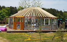 a group of people standing around a wooden structure