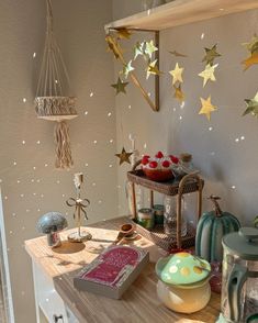 a wooden table topped with lots of items on top of a white counter next to a window