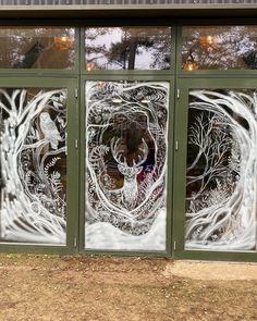 an image of a glass window with trees in it