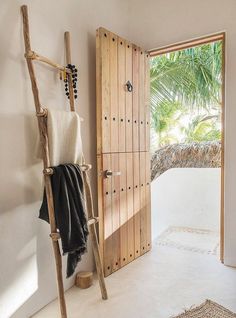 a bathroom with a wooden door and towel rack