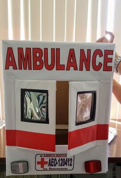 an ambulance made out of cardboard sitting on top of a table