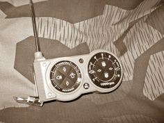 two dials are attached to the side of a radio on a bed sheet with an abstract background