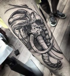 an elephant with some sort of design on it's arm and leg, in black and white