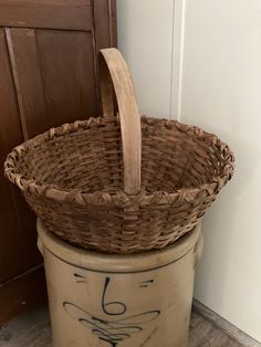 a basket that is sitting on top of a trash can