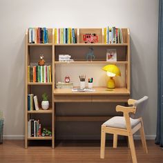 a wooden desk and chair in front of a bookshelf