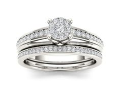 a white gold wedding ring set with two matching bands and a round diamond in the center