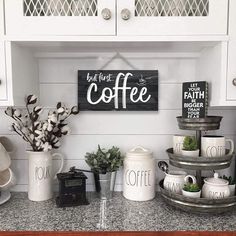 a coffee bar with cups and mugs sitting on top of the counter in a kitchen