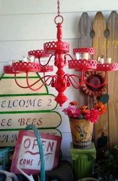 a red candelabra sitting on top of a table next to some flowers