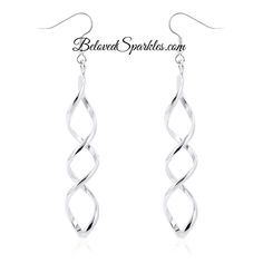 Casilda Silvertone Twist Fashion Dangle Earrings Silver twist elongated loop earrings at a 3in length. Silver rhodium polished into a lustrous silvertone finish. Silver hued metals twist into a drop design that's contemporary and fashionable. Item: BSJG-DE101630X00 Plating Color: Silvertone Rhodium Base Metal: Lead Free Alloy (Brass) Adornment Size: 83.8mm L (3.3in) x 10.6mm W (0.4in) Back Type: French Hook Dangle & Drop Earrings: www.etsy.com/shop/BelovedSparkles?section_id=15675572&ref=shopsec Twist Earrings, Drop Design, Clover Earrings, Cubic Zirconia Jewelry, Loop Earrings, Discount Jewelry, Silver Earrings Dangle, Cleaning Jewelry, Earrings Silver