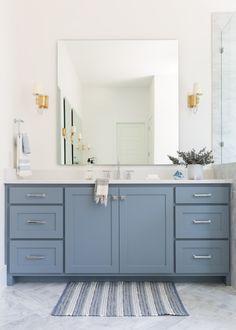 a bathroom with two sinks and a large mirror