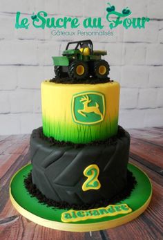 a three tiered cake decorated with green and yellow frosting, featuring a tractor