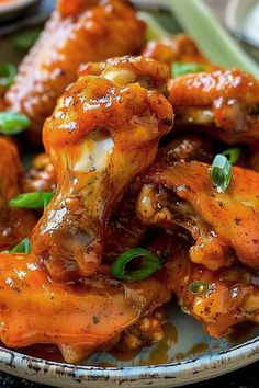 chicken wings covered in sauce on a plate