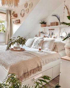 a bedroom with white walls and lots of plants