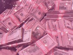 a pile of money sitting on top of each other in front of a pink background