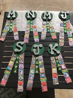 a table topped with lots of green and white paper cut out to spell the word st patrick's day