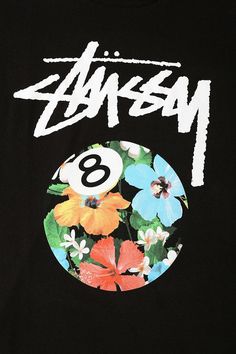 a man wearing a black t - shirt with flowers and the number eight on it