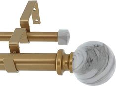 two white and gold door handles with marble knobs on each side, one in the shape of a ball