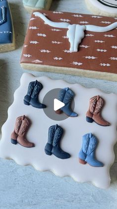 cookies decorated with cowboy boots are sitting on a table