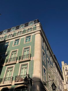 the building has many windows and balconies on it's sides as well