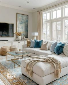 a living room filled with furniture and a large window covered in lots of natural light