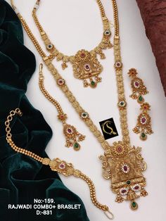 Description :- South Indian Temple Choker With Long Haram Ruby Jewelry Set, Weding Gold Necklace Set, Hasadi Set, Choker Necklace Set, Long Gold Necklace Gift yourself a royal look with this perfectly crafted kundan necklace set from Manalisstudio. Crafted with high quality kundan stones and pearls, it is impressive in design. The green enamel artwork adds perfect texture to the design. Perfect for weddings and festivities, this antique necklace set should be put on with your favorite sari or le Ruby Jewelry Set, South Indian Temple, Long Haram, Indian Temple, Royal Look, Kundan Necklace, Gold Long Necklace, Choker Necklace Set, Gold Necklace Set