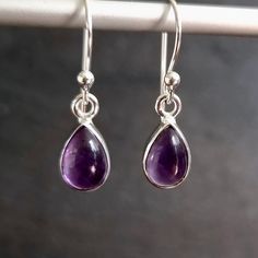 💖  Product Description Small Amethyst Earrings - Teardrop Amethyst Earrings set in 925 Sterling Silver  Amethyst is the February Birthstone and the 6th Anniversary Gemstone These earrings come in two sizes - please select from the drop down menu 💖 Product Details * 925 Sterling Silver * Handmade * Total Drop (Incl Hook) - 27mm / 28mm * Total Drop (Excl Hook) - 10mm / 12mm * Width at Widest point - 7mm / 8mm * Stone Size - 9mm x 6mm / 9mm x 7mm * Depth of Stone - 6mm * Weight - 2.3g - 2.5g 💖 Purple Drop Earrings, Earrings Teardrop, 6th Anniversary, Earrings Purple, February Birthstone, 925 Silver Earrings, Amethyst Earrings, February Birth Stone, Earrings Set