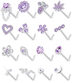 an assortment of various piercings with different shapes and colors on them, including purple crystals