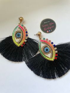 Beautiful Tassel Evil Eye Earrings.  Pick from two colors. Vibrant red or Black.  Can be perfect as a gift or for personal fashion use. Eye-catching Dangle Earrings For Party, Trendy Handmade Multicolor Plug Earrings, Trendy Multicolor Handmade Plug Earrings, Elegant Multicolor Earrings For Beach, Eye-catching Multicolor Party Earrings, Multicolor Tassel Earrings As A Gift, Multicolor Tassel Earrings For Gifts, Trendy Multicolor Dangle Plug Earrings, Unique Multicolor Tassel Earrings For Gift