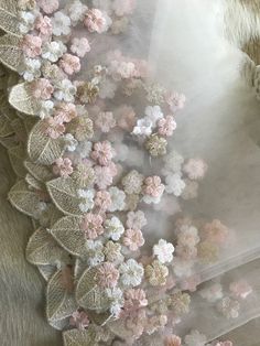 the fabric has flowers on it and is made from sheer material with lace trims