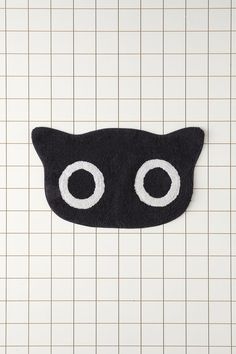 a close up of a black cat shaped rug