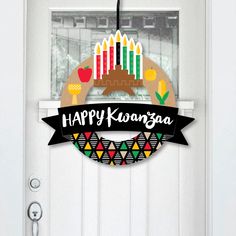 a white door with a happy karangaa sign hanging from it's side