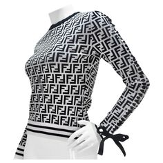 Introducing the Fendi Zucca Monogram Viscose Sweater—a versatile and stylish statement piece that seamlessly combines the iconic Fendi Zucca monogram with a touch of playful elegance. This sweater isn't just a garment; it's a wearable work of art that effortlessly blends comfort with high fashion. Envision yourself in this black and white signature Fendi Zucca monogram stretchy viscose crewneck sweater. The lace-up detail on one sleeve, adorned with a black ribbon that ties into a bow at the end Designer Monogram Print Tops For Fall, Designer Monogram Print Tops For Winter, Designer Winter Tops With Monogram Print, Fendi Monogram Outfit, Fendi Monogram, Fendi Blouse, Womens Fendi Sweater, Fendi Sweatshirt Women, Black Ribbon