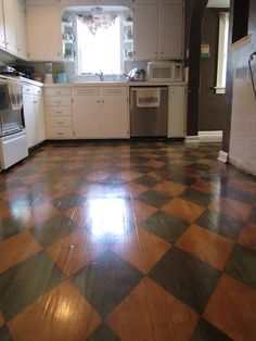 a kitchen with a checkered floor and white cabinets