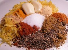 various spices and seasonings on a white plate