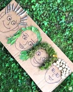 two cardboard faces are sitting on the grass