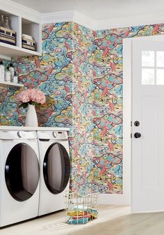 a washer and dryer in a room with wallpaper