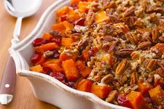 a casserole dish filled with sweet potatoes and pecans