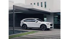 a white suv parked in front of a building