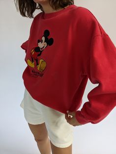 Vintage 90s nostalgic perfectly worn in Mickey Mouse pullover features a round neckline with micro ribbed detailing and an embroidered Mickey Mouse logo on the front. Perfectly paired with our waffled cotton shorts, your favorite ball cap, new balances, and your gold-toned jewelry. Tag reads Mickey Inc Subtle spots of lightening at the front middle. 90s Crew Neck Top With Embroidered Logo, Trendy Embroidered Logo Tops For Loungewear, Vintage Ribbed Cuffs Top For Spring, Vintage Tops With Ribbed Cuffs For Spring, 90s Embroidered Logo Tops For Streetwear, 90s Streetwear Tops With Embroidered Logo, 90s Style Tops With Embroidered Logo For Streetwear, Vintage Relaxed Fit Top With Embroidered Logo, 90s Crew Top With Ribbed Cuffs