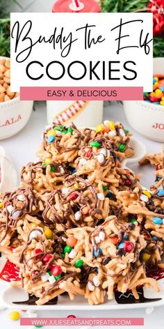 a pile of cookies on top of a white plate with candy and sprinkles