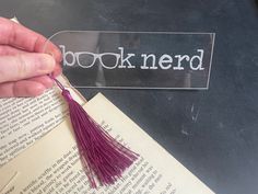 a book nerd with a purple tassel hanging from it